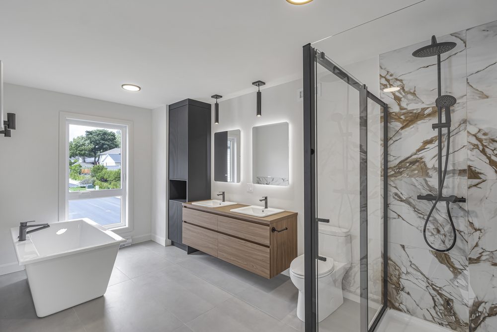 Primary bathroom in a new build: freestanding tub, double vanity and marble shower