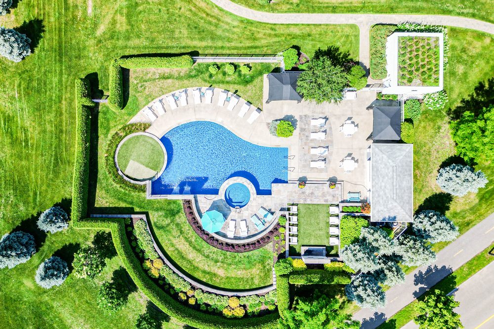 Overhead view of an in-ground pool and its landscaping